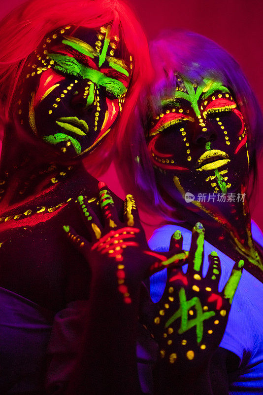 Two Young Women With Fluorescent Makeup